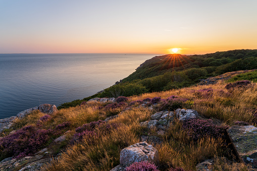 Gorgeous summer sunset from top of mountain at Kullaberg nature reserve in southern Sweden.