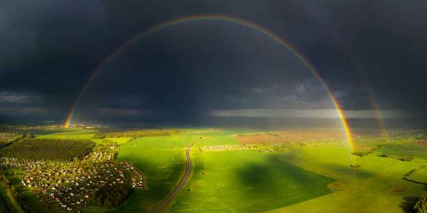 istock Bright rainbow over green field 1335978002