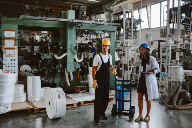 istock Female technician discussing work at the plastic up-cycling facility 1335984780