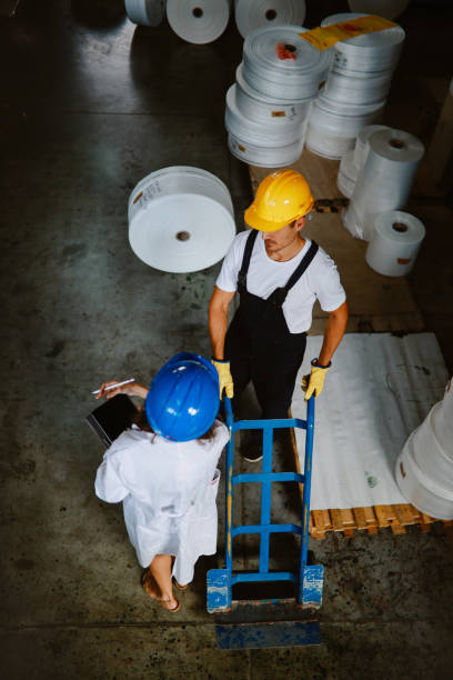 istock Female technician discussing work at the plastic up-cycling facility 1335984937