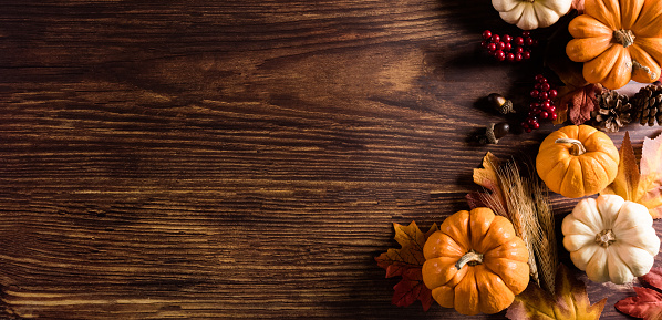 istock Autumn background decoration from dry leaves and pumpkin on old wooden background. Flat lay, top view with copy space for fall and  Thanksgiving concept. 1335990239