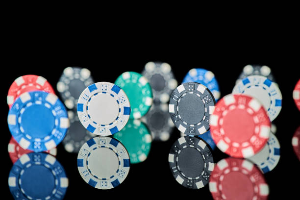 istock Casino gambling chips isolated on black reflective background 1335994234