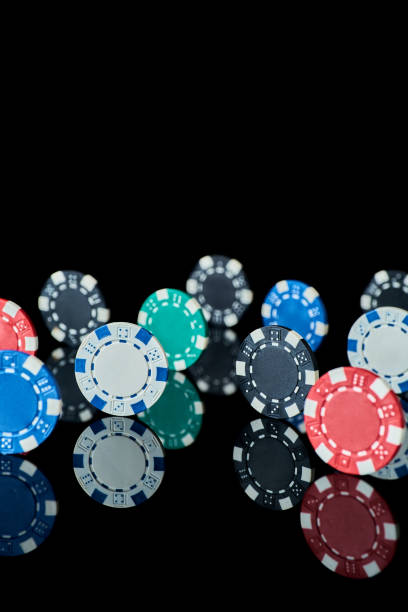 istock Casino gambling chips isolated on black reflective background 1335994239