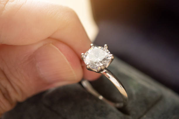 istock hand hold beautiful jewelry diamond ring 1335994271