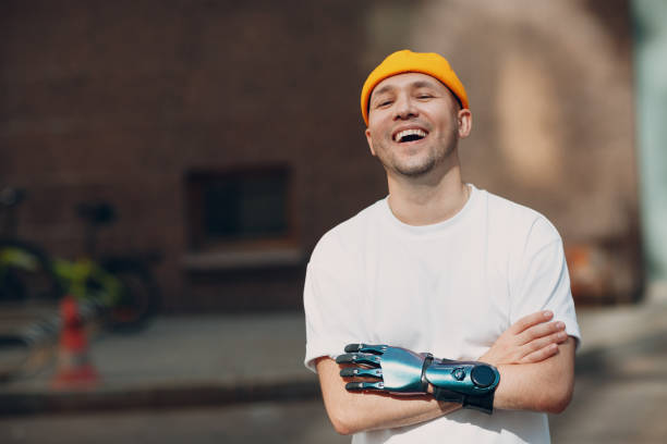 Young disabled man with artificial prosthetic hand in casual clothes.