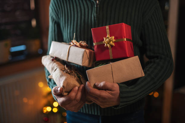 istock Man Holding Organic Christmas Presents. 1335994334