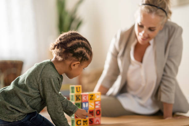istock Young boy at a play exercise with an occupational therapist 1335994478