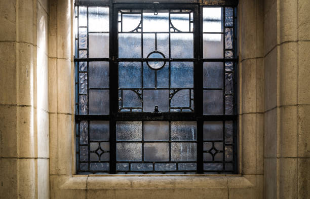 istock Simple patterned antique stained glass window frame in ancient building. 1335994742
