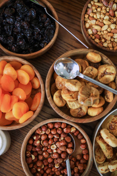 istock dried apricots, hazelnuts, black grapes, healthy foods 1335996351