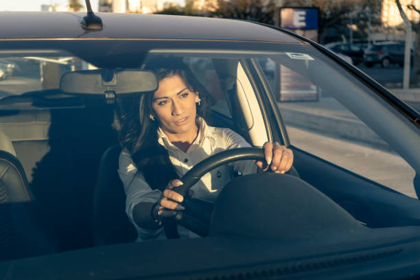 istock Latin woman driving a car. Mobility concept. 1336005514