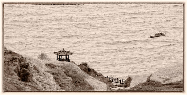 istock An octagonal pavilion on the beach with fish boats floating leisurely 1336006300