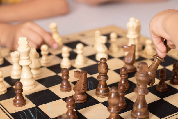 istock children playing wooden chess on the table 1336006379