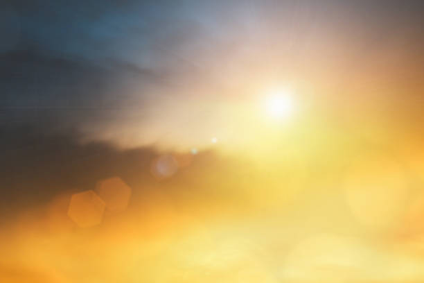 Natural background blurring warm colors and bright sun light. Bokeh or Christmas background Green Energy at sky sunny color orange light patterns plain abstract flare evening clouds blur.