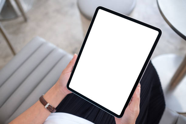 istock a woman holding digital tablet with blank white desktop screen 1336009377