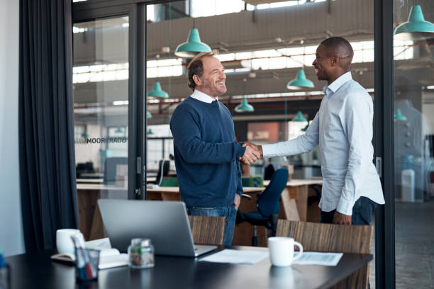 istock Shot of two businessmen shaking hands in a modern office 1336009421