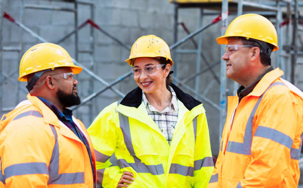 istock Hispanic woman meets with coworkers at construction site 1336009700