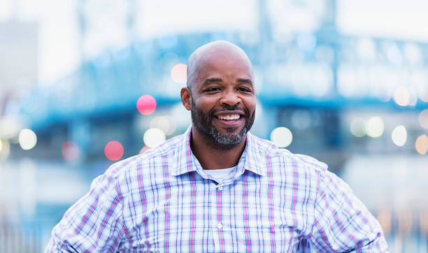 istock Mature African-American man on city waterfront smiling 1336010254