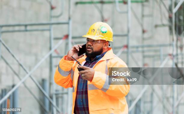 Construction Worker At Job Site Talking On Mobile Phone Stock Photo - Download Image Now