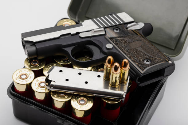 istock Semi automatic hand gun with bullet magazine on shotgun shell background 1336011209
