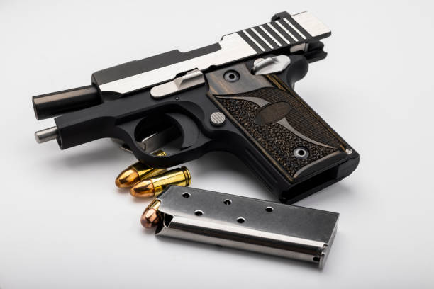 istock Semi automatic pocket gun with bullet magazine on white background 1336011210