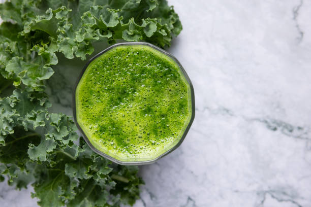 istock Fresh organic green kale leaves pattern on a white background 1336011688