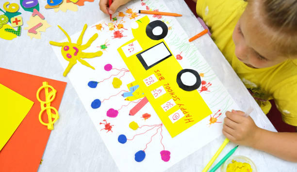 istock Child making school bus from paper and plasticine. 1336015604