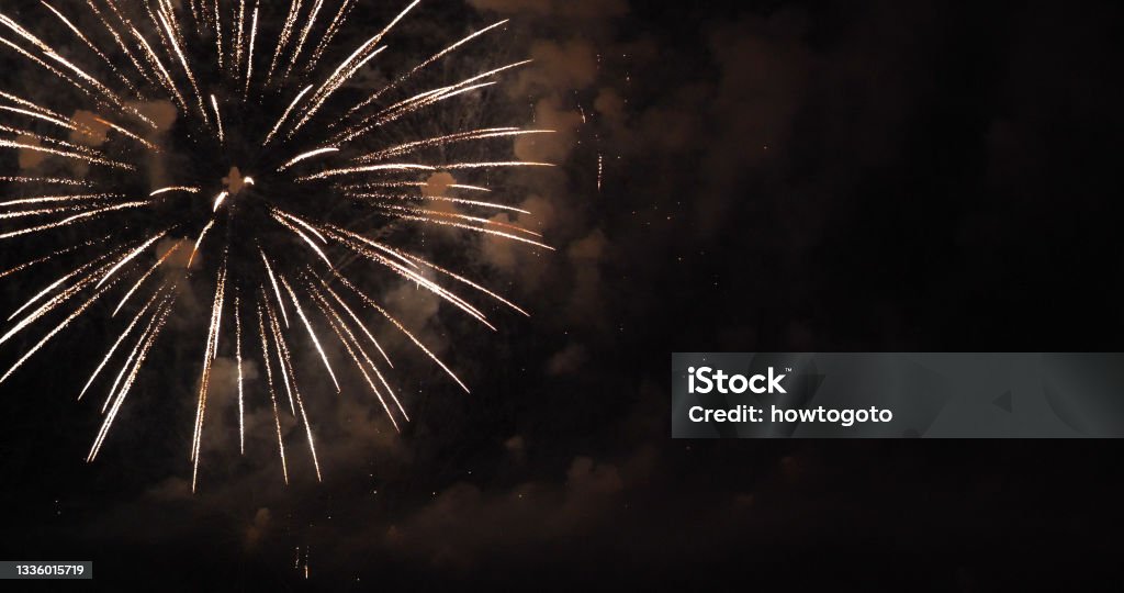 Golden Firework celebrate anniversary happy new year 2022, 4th of july holiday festival. Gold firework in the night time celebrate national holiday. Countdown to new year 2022 gold party time event 2022 Stock Photo