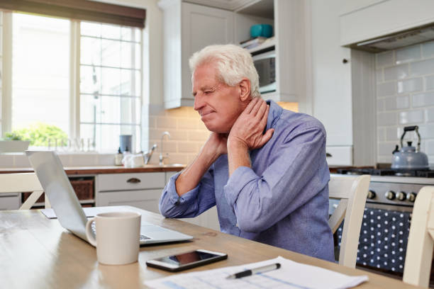 istock Shot of a senior man looking stressed while using laptop and going through paperwork at home 1336017321