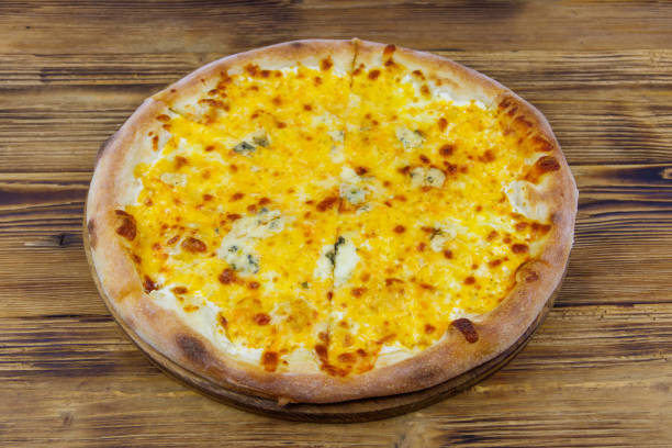 istock Pizza Four cheese on a wooden background 1336017419