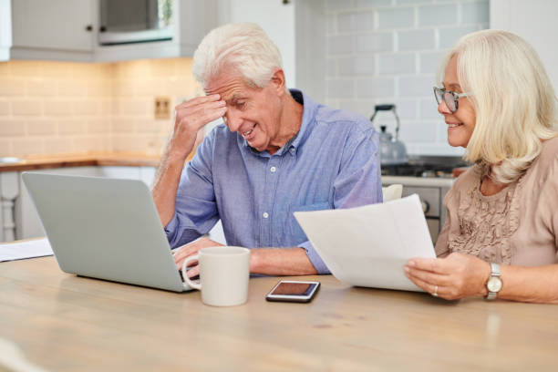 istock Shot of a senior couple looking unhappy while going through paperwork at home 1336018935