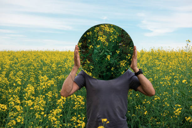 istock Man standing in yellow flowers 1336026175