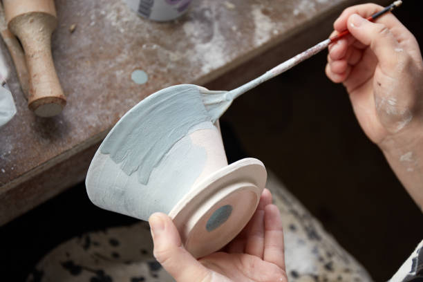 istock Pottery studio The process of creating pottery. The master ceramist works in her studio. workplace of potter 1336029000