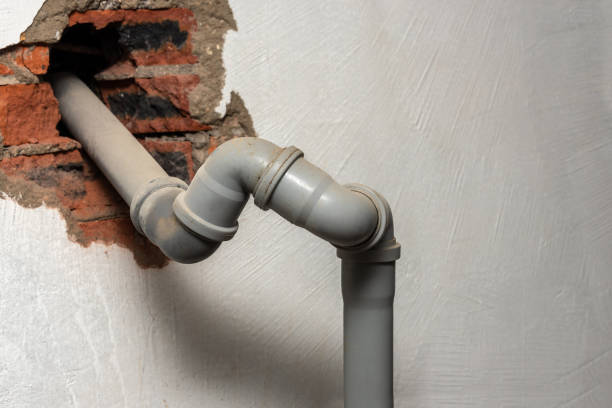 istock A plastic gray sewer pipe emerges from a hole in a brick wall. 1336029047