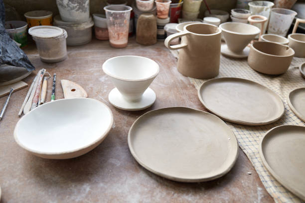 istock Pottery studio The process of creating pottery. The master ceramist works in her studio. workplace of potter 1336029087