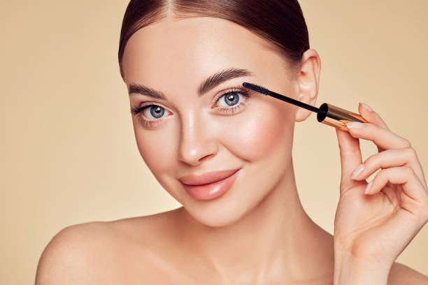 istock Beauty woman applying black mascara on eyelashes 1336033092