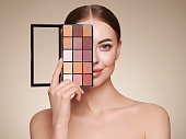 Beauty woman with eye shadow makeup palette
