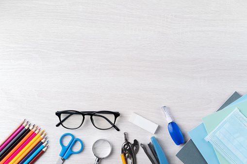 Back to school student design concept, top view of stationery over wooden table background with copy space.