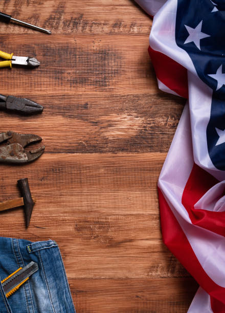 istock Top view design concept of Labor Day with working tools and jeans. 1336034723