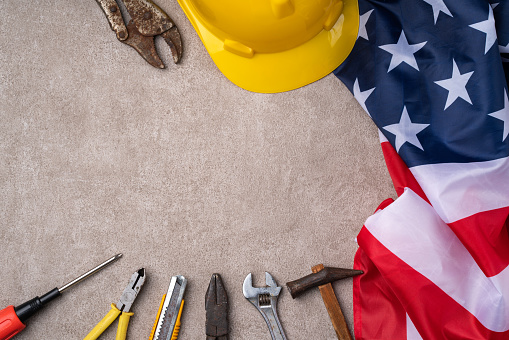 Top view design concept of American Labor Day with working tools.