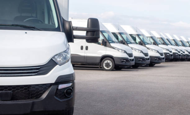 White delivery vans in a row. Express delivery and shipment service. Transporting service company