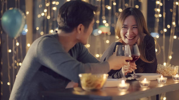 istock Young couple enjoying the drinks against glitter lights 1336039282