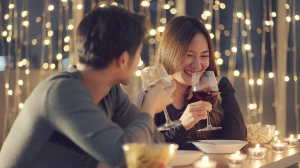 Couple enjoying the wine at dinner stock photo