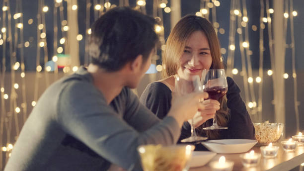 Couple enjoying the wine at dinner stock photo
