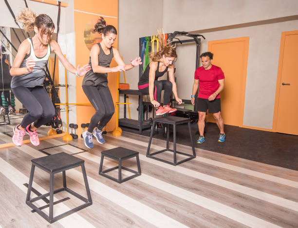 istock Athletes women doing box jumps at gym 1336042963