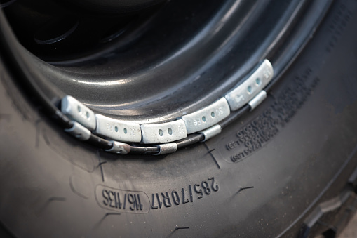 Lead weight on black car rims. using for vehicle wheel balance.