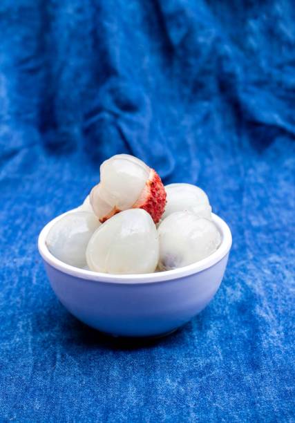 istock Peeled Lychee or Litchi in a Bowl Isolated on Blue Fabric Background 1336045487