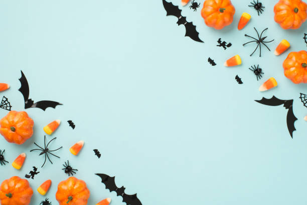 istock Top view photo of halloween decorations pumpkins candy corn spiders web witch and bats silhouettes on isolated light blue background with copyspace 1336046248