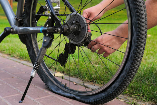 istock A bicycle with a flat rear wheel parked on a city road 1336049364