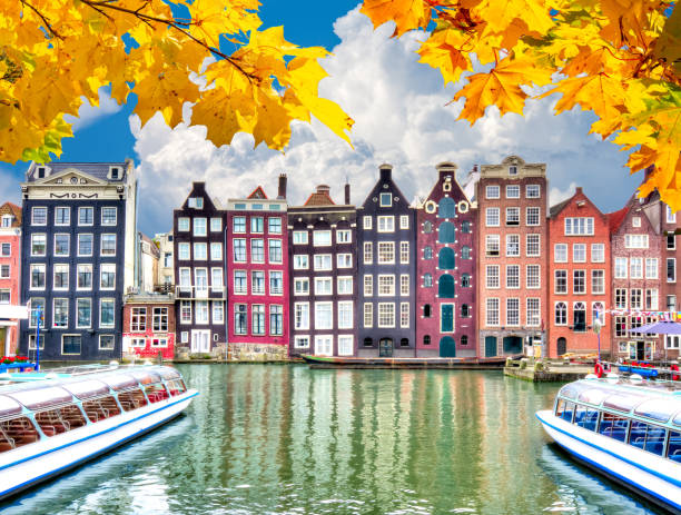istock Amsterdam architecture at Damrak canal in autumn, Netherlands 1336051340