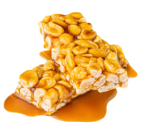istock Nut bar with peanuts and melted caramel syrup isolated on white background. Crushed Muesli energy cereal snack 1336051421